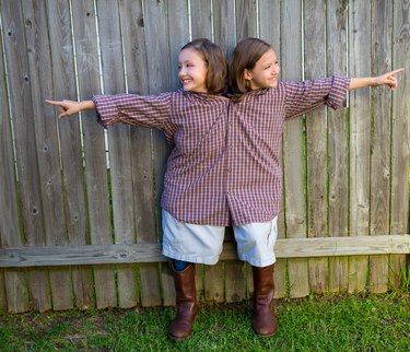 twin girls dressed up as siamese with his father shirt