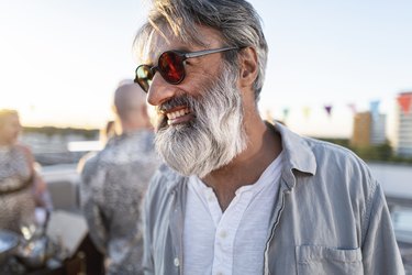 smiling hipster man on a rooftop party in munich