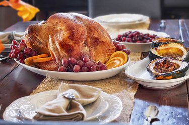 Thanksgiving Day table set with Roasted Prepared Turkey
