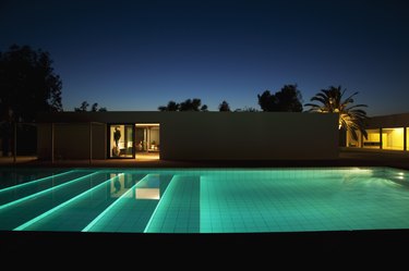 Pool outside modern house at twilight