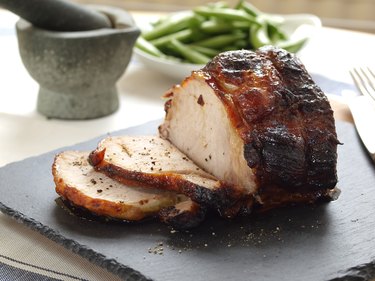 Roasted pork loin on a cutting board.