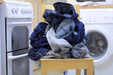 laundry on a chair by a washing machine