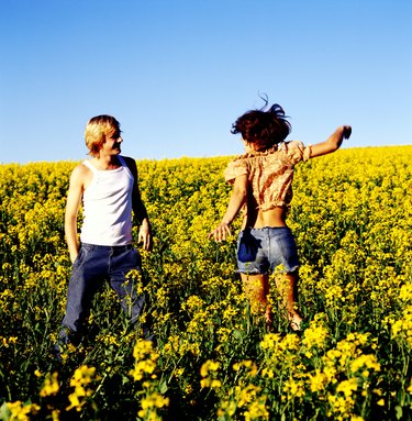 Young couple standing together in a field of flowers