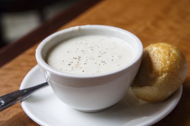 Bowl of New England Clam Chowder and a Yeast Roll