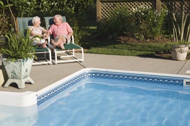 Couple sitting poolside