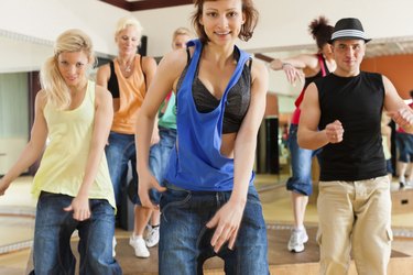 Zumba or Jazzdance - young people dancing in studio