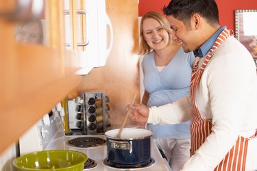 Couple cooking together in kitchen