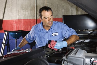 Auto mechanic fixing vehicle