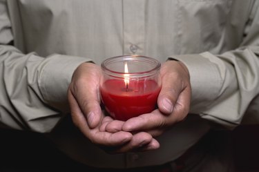 Man holding burning candle