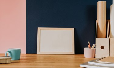 Your text here - empty frame on wooden desk