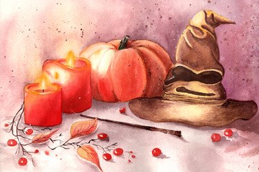 Halloween decorations with Gryffindor hat , pumpkin,  red berries, two red candles  and Harry Potter magic wand