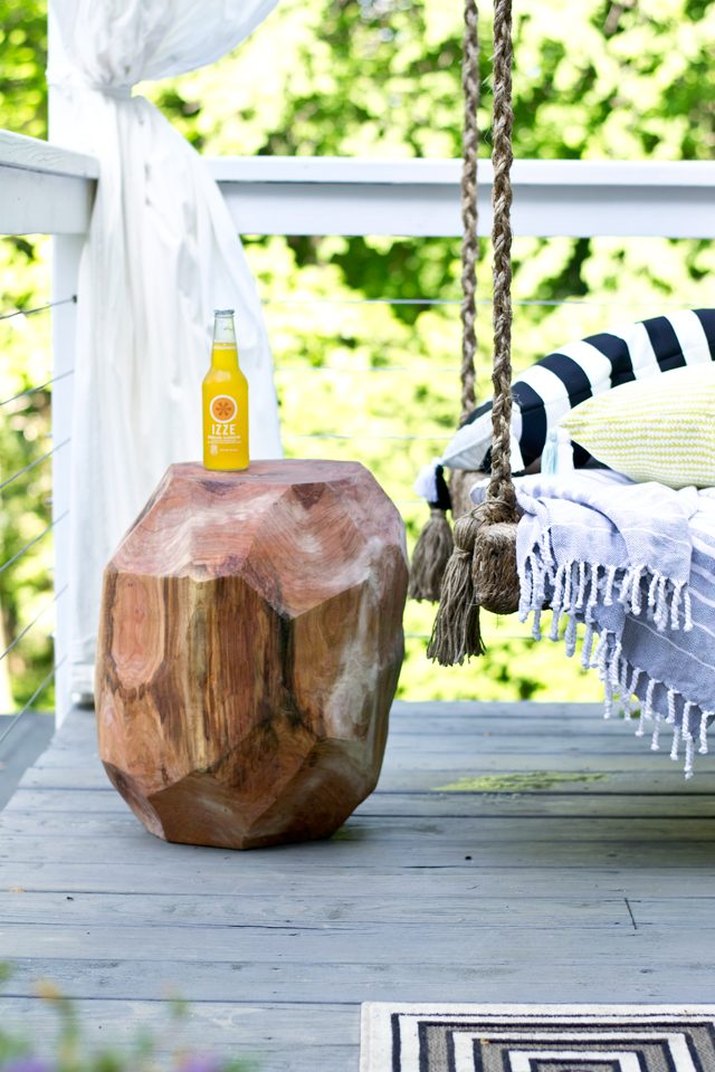 A side table made out of a tree trunk.