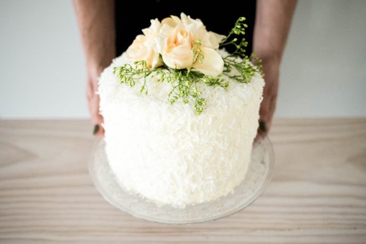 A beautifully decorated Tres Leches cake studded with shredded coconut.