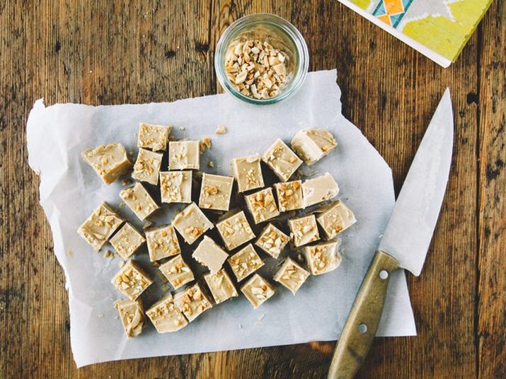 Squares of peanut butter fudge on a paper towel