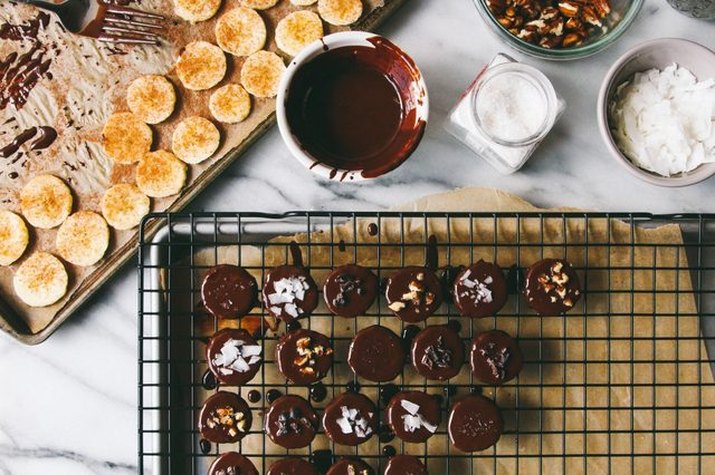 A counter for preparing dark chocolate-covered banana bites.
