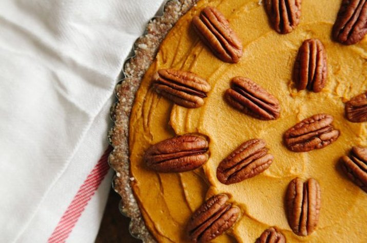 A no-bake pumpkin pie decorated with whole pecans.