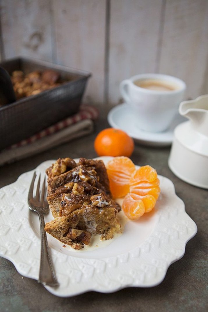 A slice of French toast breakfast bake served with tangerines and coffee.