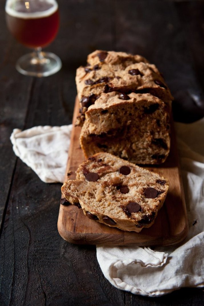 A loaf of freshly baked pumpkin chocolate chip beer bread served with a pumpkin ale.