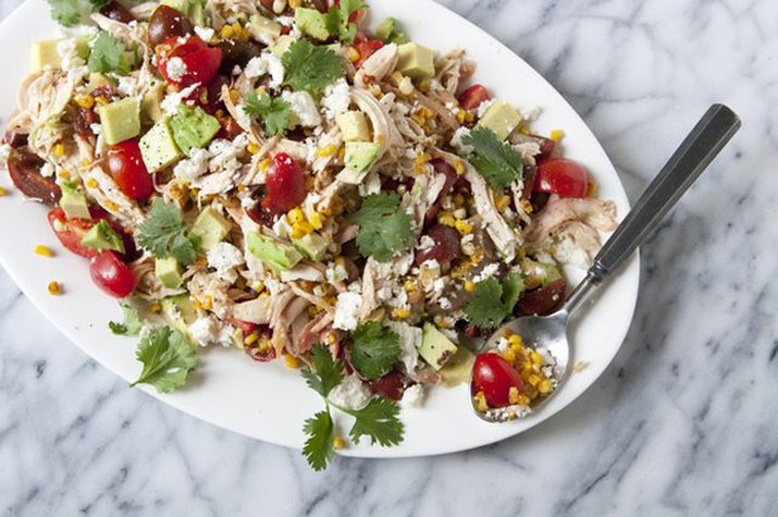 A plate of freshly made charred corn with chicken and cheese salad.