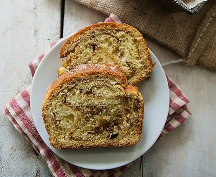 Two slices of cinnamon swirl bread on a white plate