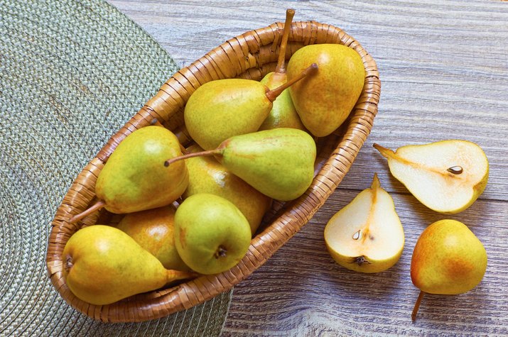 Pears in basket on table
